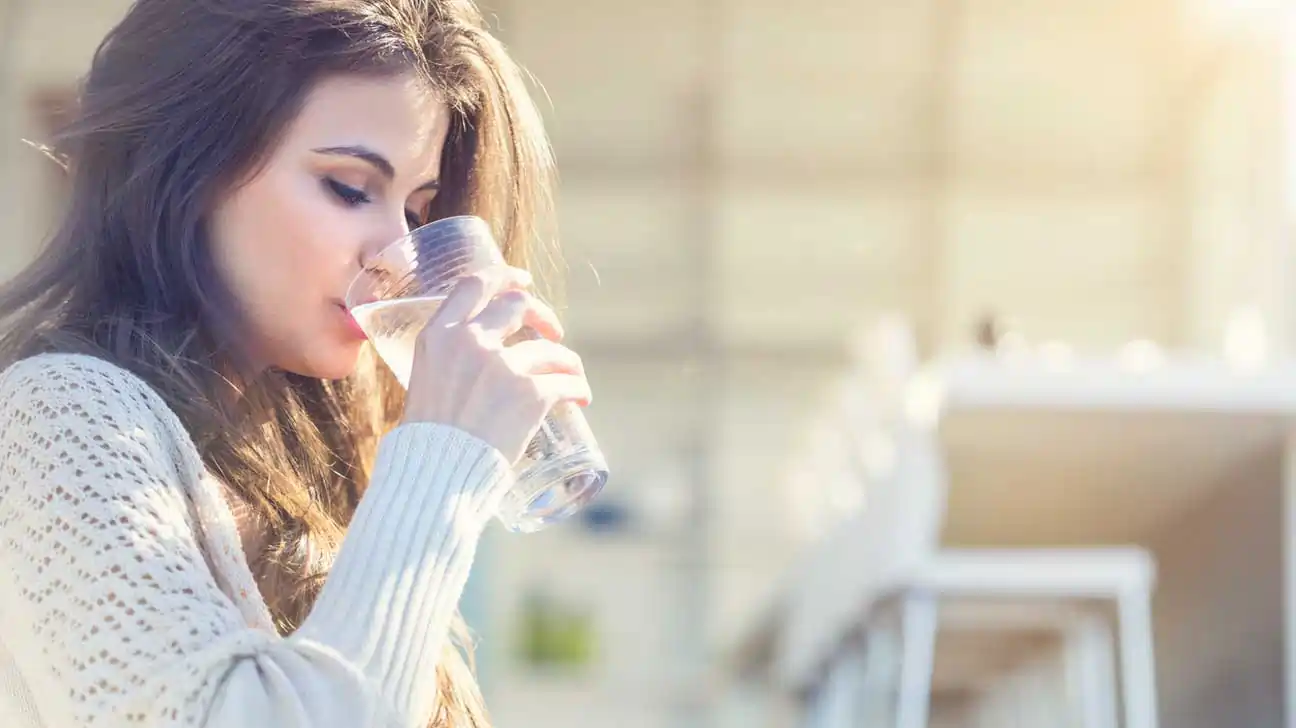 woman drinking water 1296x728 1